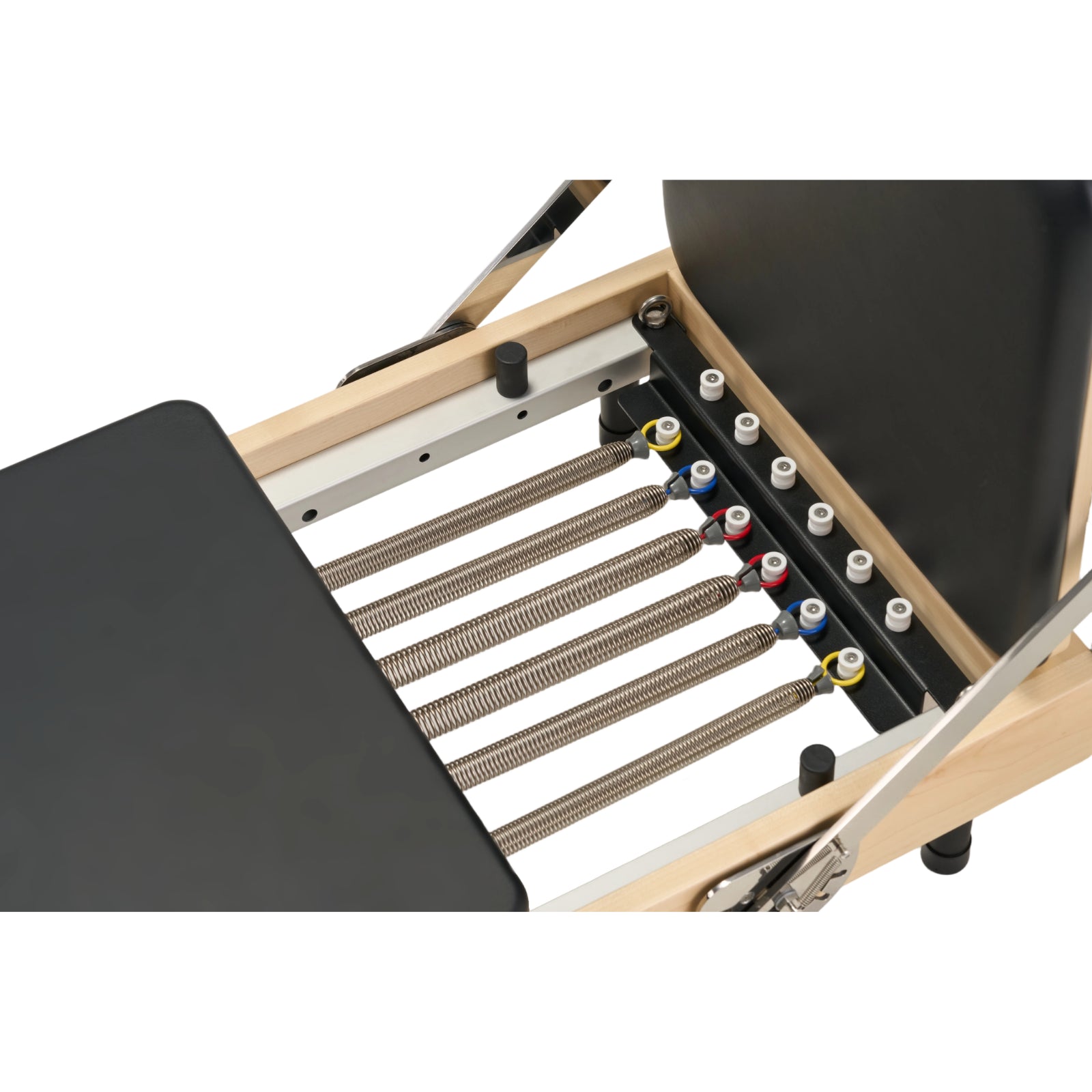 Professional 5-spring resistance system on Nestor maple wood reformer with varying tension levels.