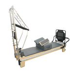 Angled view of Timber Plus maple reformer showing the integrated tower springs and push-through bar system.