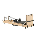 Sleek side profile of Nestor maple wood reformer, highlighting the light natural wood grain and foldable frame.