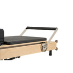 Adjustable padded footbar of Nestor maple reformer, offering multiple positions for diverse pilates exercises.