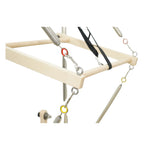 Detailed view of the push-through bar on Timber Pro maple reformer, featuring safety strap and spring tension.