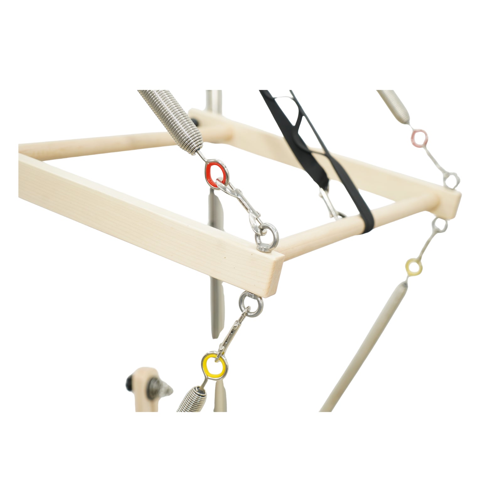 Detailed view of the push-through bar on Timber Pro maple reformer, featuring safety strap and spring tension.