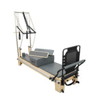 Timber Plus pilates reformer with tower, featuring handcrafted maple wood frame and adjustable resistance springs.