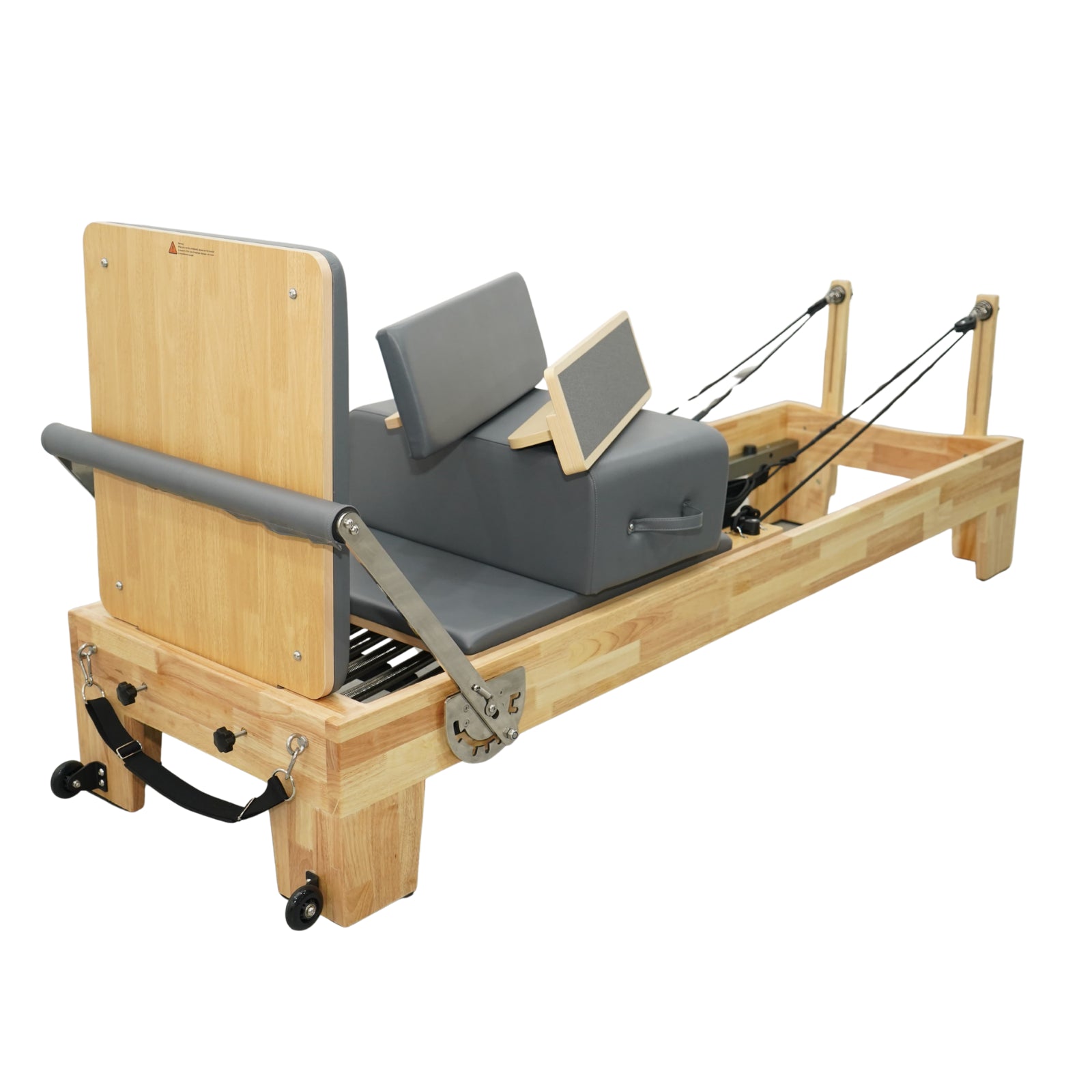 Rear view of Grove oak reformer, highlighting the sturdy wooden risers and professional rope system.